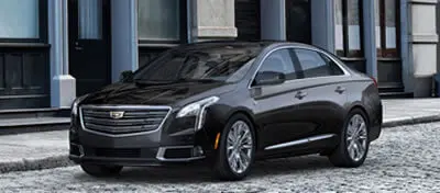 A black car parked in front of a building.