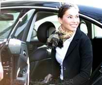 A woman in black jacket sitting inside of car.